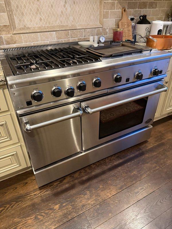 Responded to emergency service call for reported gas leak in kitchen. Conducted gas leak detection around stove and identified active leak from one burner valve that was emitting gas even when control knob was in off position. Explained to homeowner that stove repair is outside our scope of service and provided referrals to qualified appliance repair companies.