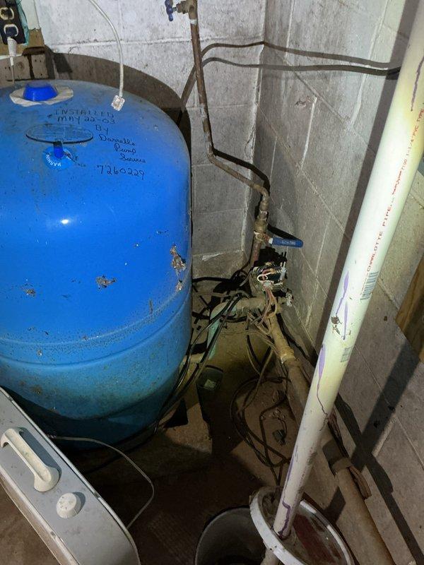 Conducted a follow-up inspection of basement plumbing system for insurance adjuster evaluation. Assessed aged copper piping network and pressure tank showing signs of water damage on surrounding concrete block walls. Documented condition of utility area infrastructure to prepare comprehensive replacement estimate as requested by customer.