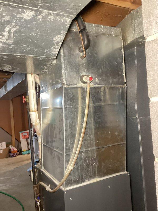 Performed comprehensive furnace tune-up on aging system after customer reported rattling noise during operation. Inspection revealed clean and balanced blower with no wheel debris, but secondary heat exchanger beginning to plug up and significantly clogged evaporator coil causing 15-20°F temperature differential. System maintained adequate 65-70°F temperature rise during extended testing; recommended monthly filter replacement and provided options for coil and burner cleaning services.