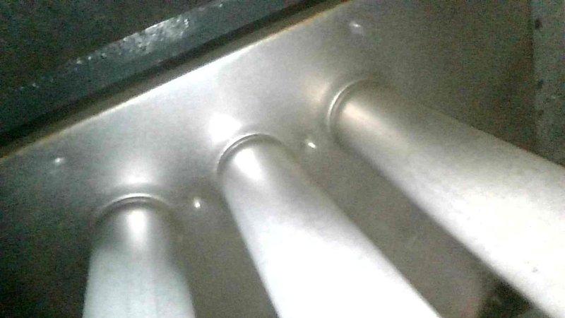 Performed comprehensive furnace tune-up on aging system after customer reported rattling noise during operation. Inspection revealed clean and balanced blower with no wheel debris, but secondary heat exchanger beginning to plug up and significantly clogged evaporator coil causing 15-20°F temperature differential. System maintained adequate 65-70°F temperature rise during extended testing; recommended monthly filter replacement and provided options for coil and burner cleaning services.