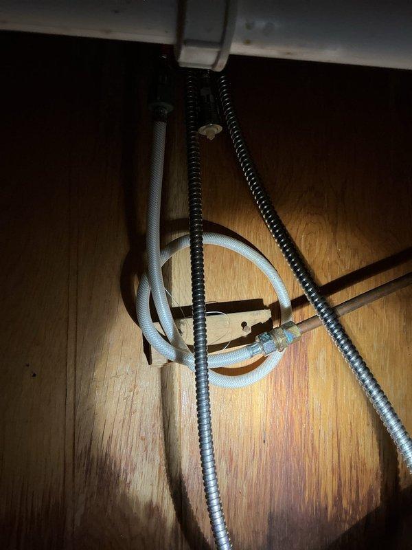 Responded to a service call for multiple water leaks resulting from frozen pipe damage. Discovered and addressed three separate issues: 1) repaired a small hole in kitchen sink supply line and replaced broken supply line on opposite side, installing two new shut-offs; 2) replaced damaged condensate pump line in basement that had been compromised by squirrel activity; 3) identified leak in water main before shut-off valve and discussed repair options with homeowner.