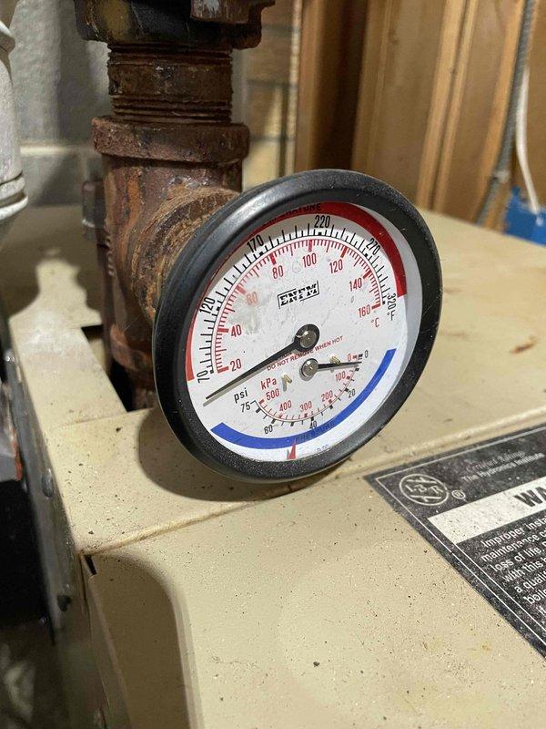 Responded to no heat call for Weil McClain boiler system. Diagnosed locked inducer motor as primary cause of failure. Successfully freed and restored inducer motor operation temporarily, restoring heat to residence. Observed significant corrosion on pipe connections and pressure gauge assembly, indicating system age and deterioration consistent with equipment exceeding 10-year lifespan. Recommended system replacement due to age-related issues and scheduled follow-up consultation.