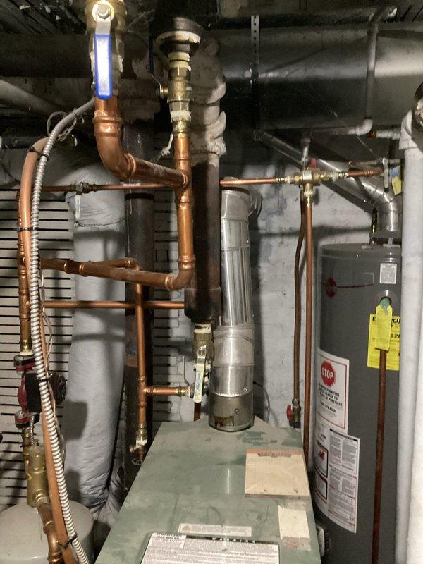 Performed scheduled maintenance on residential boiler system. Found boiler temperature set too low (adjusted to 175°) and identified a seized radiator valve in upper level bedroom. Successfully bled air from upper level radiator and verified proper operation of the heating system.