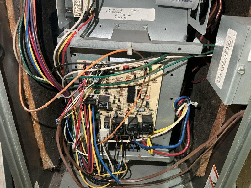 Responded to service call for 20-year-old RUUD furnace failing to maintain temperature. Diagnostic testing revealed multiple critical issues: high amp readings on inducer draft motor, oil leakage from blower motor, stress points in heat exchanger with possible perforation, and suspected intermittent voltage drops from control board causing random shutdowns without error codes. Due to age and multiple component failures, replacement was recommended and scheduled.