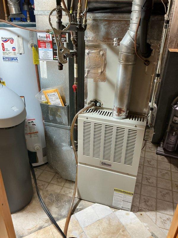 Diagnosed water softener experiencing salt bridging issue (salt dam), preventing proper regeneration cycles. Inspected adjacent Richmond Integra water heater and Gibson HVAC system to ensure no related issues. Scheduled follow-up appointment to perform complete service on water softener and provide customer with water heater replacement options.