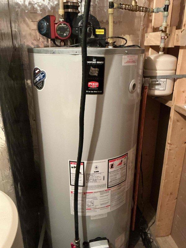 Responded to air quality sensor alarm activation in mechanical room. Performed comprehensive inspection of Bradford White natural gas water heater (2015 model) including combustion testing, exhaust system evaluation, gas leak detection, and examination of sealed combustion door gasket and power vent gasket. All tests confirmed proper operation with no combustion issues, gas leaks, or ventilation problems. Determined probable cause to be external wood smoke from neighboring property being drawn into fresh air intake.