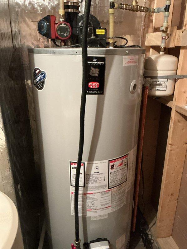 Responded to air quality sensor alarm activation in mechanical room. Performed comprehensive inspection of Bradford White natural gas water heater (2015 model) including combustion testing, exhaust system evaluation, gas leak detection, and examination of sealed combustion door gasket and power vent gasket. All tests confirmed proper operation with no combustion issues, gas leaks, or ventilation problems. Determined probable cause to be external wood smoke from neighboring property being drawn into fresh air intake.