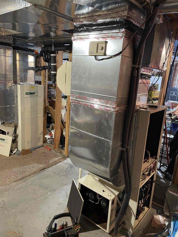 Diagnosed dual geothermal heat pump system failure due to refrigerant issues. Found upstairs unit completely depleted of charge and main level unit experiencing low pressure cutout. Verified loop field pressure and water flow were adequate. Added approximately 2 lbs of R410A refrigerant with leak detection dye to main level unit to restore temporary heating function while scheduling follow-up appointment to discuss system replacement options.