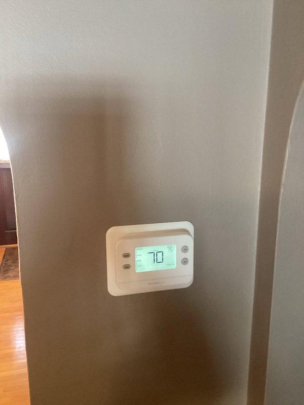 Installed customer-supplied thermostat and corrected existing furnace operational issues. Removed improper W1-to-W2 jumper and adjusted dip-switch settings to enable proper staging sequence (10 minutes in first stage before engaging second stage). Noted and informed customer about aging inducer motor showing signs of noise and leakage. Scheduled follow-up consultation for inducer replacement estimate and potential system replacement options.