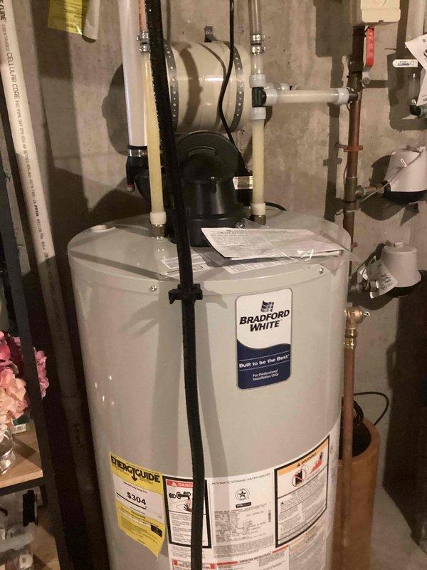 Inspected one-year-old Bradford White tank water heater reported for insufficient hot water during consecutive showers. Performed diagnostic evaluation and determined system is operating correctly. Customer experienced temporary shortage during period of high guest usage. No repairs needed as water heater is functioning properly with adequate hot water supply to both levels of the home.