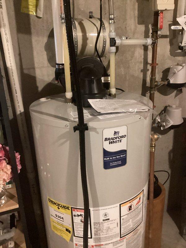 Inspected one-year-old Bradford White tank water heater reported for insufficient hot water during consecutive showers. Performed diagnostic evaluation and determined system is operating correctly. Customer experienced temporary shortage during period of high guest usage. No repairs needed as water heater is functioning properly with adequate hot water supply to both levels of the home.