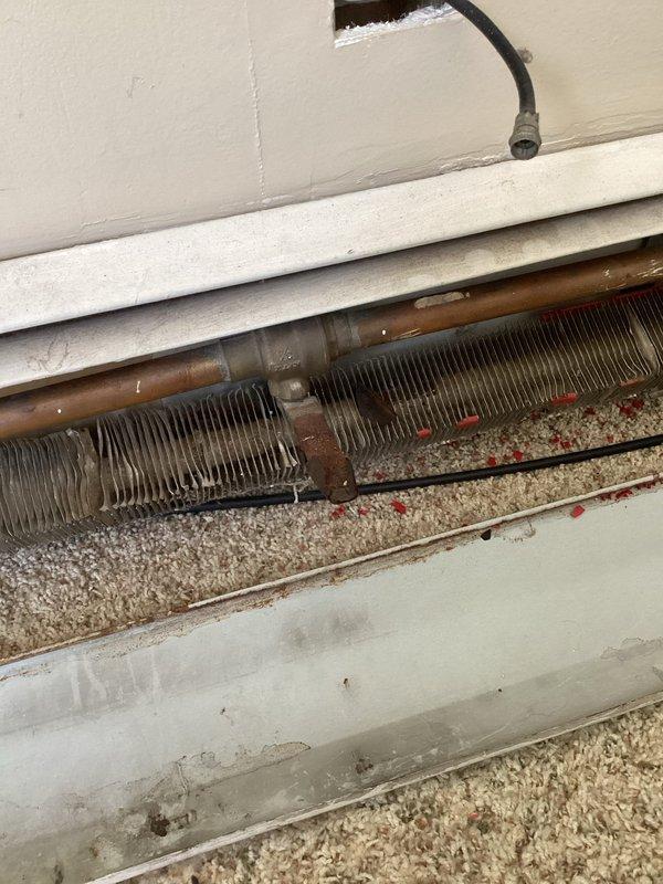 Diagnosed overheating issue in unit caused by a failed zone valve motor that had been previously forced open by maintenance personnel. Temporarily closed the valve to reduce heat in unit while documenting the required replacement part. Customer advised that valve may need to be reopened if neighbors report heat loss prior to permanent repair.