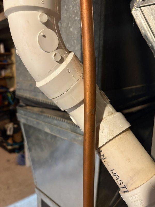 Responded to warranty service call for furnace installed 4 months ago. Identified condensation leak from PVC exhaust pipe affecting basement floor. Initial attempt to seal with additional adhesive was unsuccessful; resolved issue by removing damaged section and installing new PVC fittings, successfully eliminating the leak.