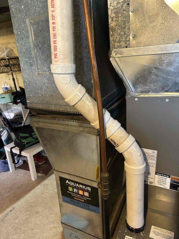 Responded to warranty service call for furnace installed 4 months ago. Identified condensation leak from PVC exhaust pipe affecting basement floor. Initial attempt to seal with additional adhesive was unsuccessful; resolved issue by removing damaged section and installing new PVC fittings, successfully eliminating the leak.