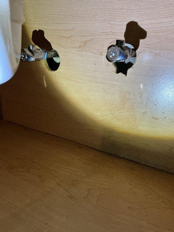 Responded to customer complaint of a leaking washing machine supply line. Discovered improvised valve assembly that was causing the leak. Removed makeshift assembly and installed two new angle stops for laboratory faucet connection and two properly fitted boiler drains for washing machine hookups in basement, resolving the leak issue.