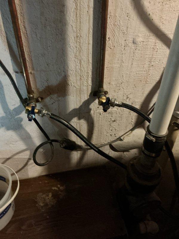Responded to customer complaint of a leaking washing machine supply line. Discovered improvised valve assembly that was causing the leak. Removed makeshift assembly and installed two new angle stops for laboratory faucet connection and two properly fitted boiler drains for washing machine hookups in basement, resolving the leak issue.
