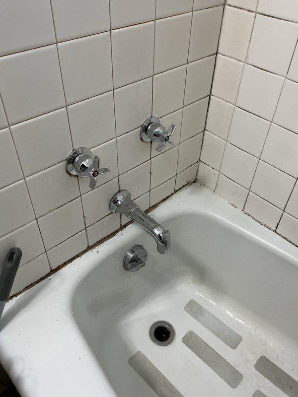 Completed replacement of 50-year-old leaking tub/shower valve with new Moen Chateau Chrome L2353 system, including valve, spout, and shower head. Installation included Posi-Temp® pressure-balance technology and lever handle for improved functionality and water control. Work required accessing plumbing through wall cavity where significant age-related deterioration was observed around the original plumbing components.