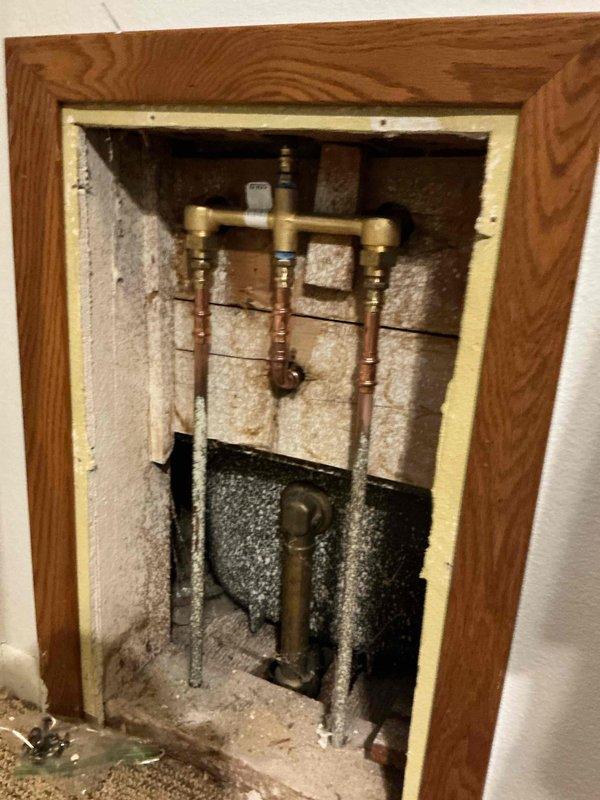 Completed replacement of 50-year-old leaking tub/shower valve with new Moen Chateau Chrome L2353 system, including valve, spout, and shower head. Installation included Posi-Temp® pressure-balance technology and lever handle for improved functionality and water control. Work required accessing plumbing through wall cavity where significant age-related deterioration was observed around the original plumbing components.
