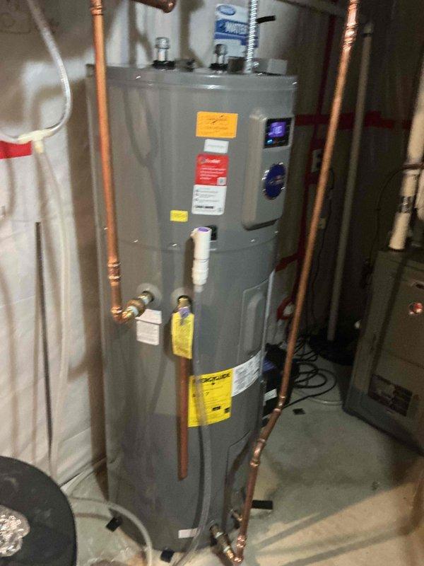 Responded to service call for 7-year-old natural gas furnace reported to be leaking water from the bottom. Conducted thorough diagnostic testing, including running the furnace for one hour and cycling the humidifier 12-15 times, with all components functioning properly and draining as designed. Inspection revealed no current water leakage or evidence of moisture inside the furnace; noted that previous water observed may have been related to the recently replaced water heater.