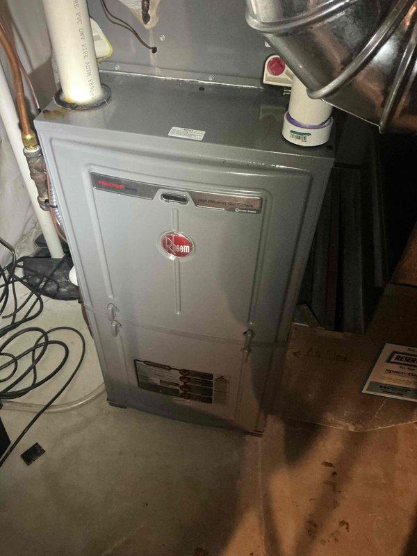 Responded to service call for 7-year-old natural gas furnace reported to be leaking water from the bottom. Conducted thorough diagnostic testing, including running the furnace for one hour and cycling the humidifier 12-15 times, with all components functioning properly and draining as designed. Inspection revealed no current water leakage or evidence of moisture inside the furnace; noted that previous water observed may have been related to the recently replaced water heater.