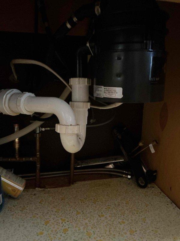 Replaced leaking garbage disposal unit in kitchen sink. Inspection revealed water was seeping from the sink strainer connection rather than disposal seal as initially suspected. New disposal was installed with proper sealing to resolve the leak issue.
