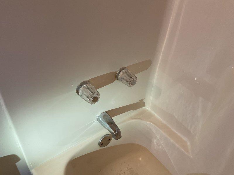Diagnosed and resolved hot water issue in downstairs bathroom by cleaning plugged bath sink aerator. Inspected two-handle tub/shower faucet and determined it was not repairable. Provided estimate for replacement of main floor and 2nd floor tub/shower faucets with Moen single handle valves, trim, and remodel plates.