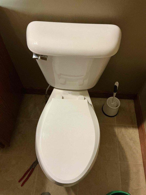 Responded to service call for toilet leaking between tank and bowl. Diagnosed issues including loose tank bolts and faulty fill valve. Tightened all three tank bolts to secure tank and eliminate leak, then replaced fill valve and flush valve gasket to restore proper function.