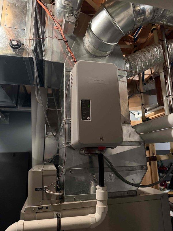 Replaced faulty steam humidifier system with new unit as sold by Mike B. Installation included new humidistat, drain line, and patching of previous mounting holes in ductwork. System is now properly installed with digital controls and properly connected to existing HVAC infrastructure.