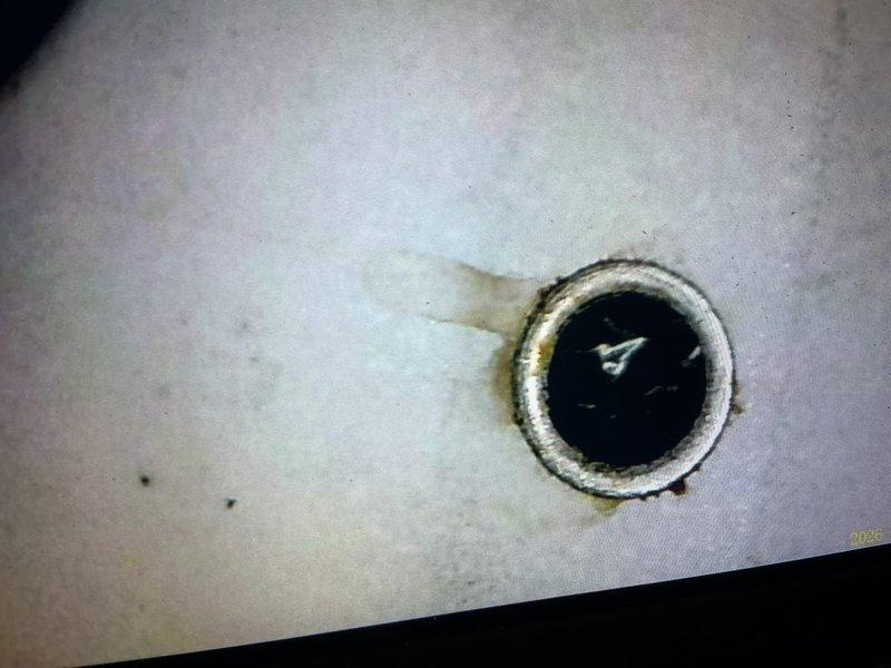 Responded to no-heat call for 18-year-old furnace. Diagnosed flame rollout condition triggering safety switch due to severely compromised heat exchanger with visible rust-through eyelets and gas leakage. Condemned unit as unsafe to operate due to extensive cabinet deterioration and scheduled replacement estimate.