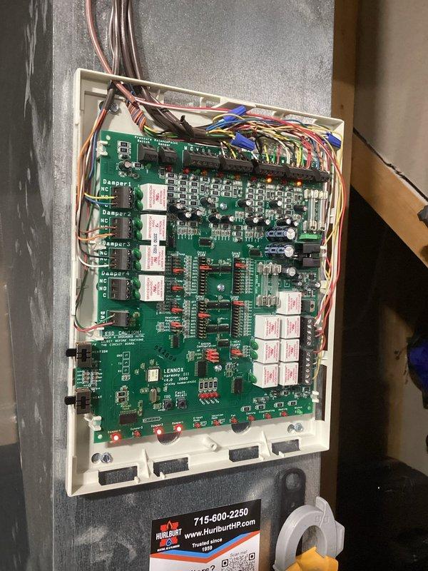 Diagnosed no heat issue with Lennox zoned system, finding improper jumper wire configuration at zone control panel (RH to O instead of required RH to Rc). Corrected jumper placement, cut onboard jumpers, and reset thermostat from programming to non-programmable mode per customer preference. System testing confirmed proper operation with fan now functioning independently and with both heating and cooling modes.