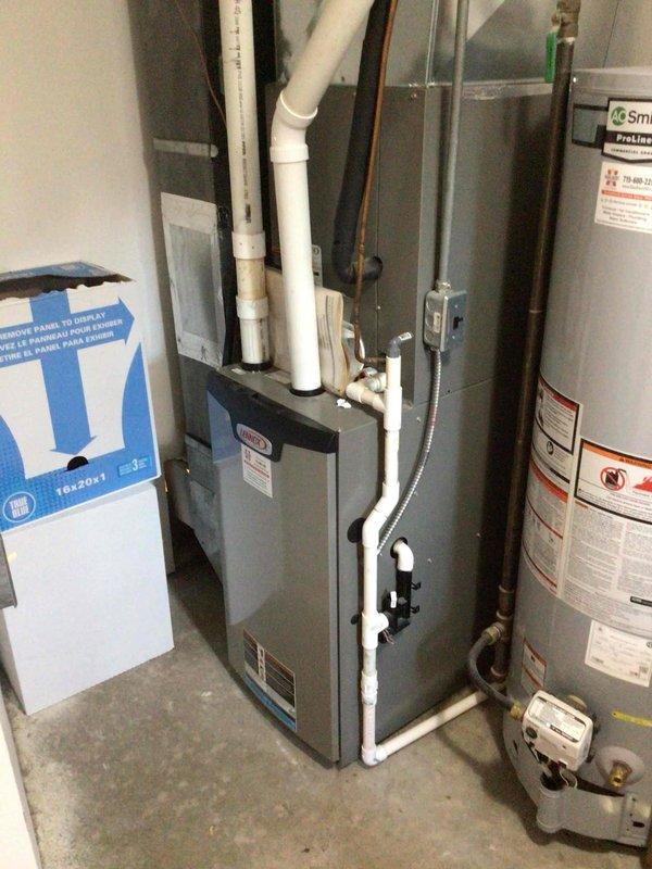 Responded to warranty service call for blower control issues. Installed blower wheel but noted continued balance problems; submitted parts order for new motor mount and squirrel cage. Documented equipment condition with photos of the electrical panel and HVAC system setup including furnace and water heater.