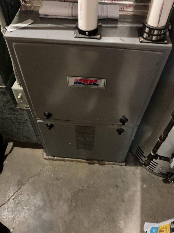 Performed routine maintenance on an 8-year-old Heil furnace system. Cleaned dirty flame sensor and identified concerning spots inside burner assembly. System is functioning properly after service; customer was informed about potential issues with the flame sensor that may require monitoring.