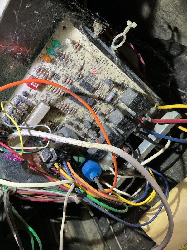 Diagnosed 23-year-old furnace with intermittent heating failure due to seizing blower motor. Replaced blower motor and wheel, performed cleaning to restore proper operation. Control board inspection revealed extensive dust accumulation and cobwebs, indicating lack of maintenance contributing to system issues.