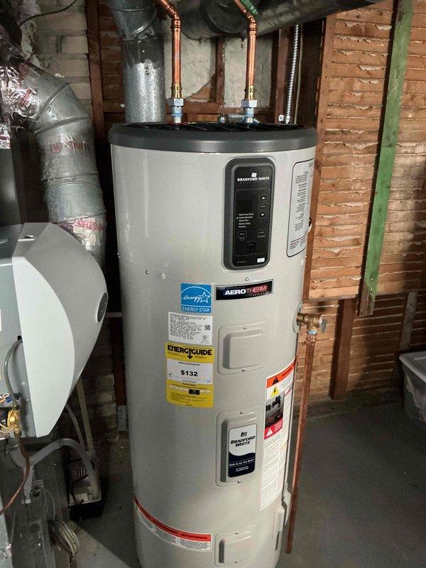 Responded to service call for recently installed heat pump not functioning properly during warm weather. Diagnostic inspection revealed system was operating in cooling mode rather than heating. Examined wiring connections and thermostat settings; determined thermostat is not properly recognizing heat pump. Documentation includes photos of water heater installation and electrical panel for reference.