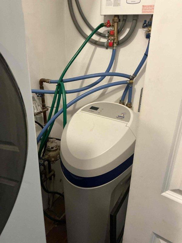 Diagnosed tankless water heater with limited hot water and malfunctioning water softener system. Inspection revealed softener was clogged and skipping regeneration cycles, while the water heater showed significant mineral buildup affecting performance. Provided options for water softener repair/replacement and tankless unit service to restore proper hot water function.