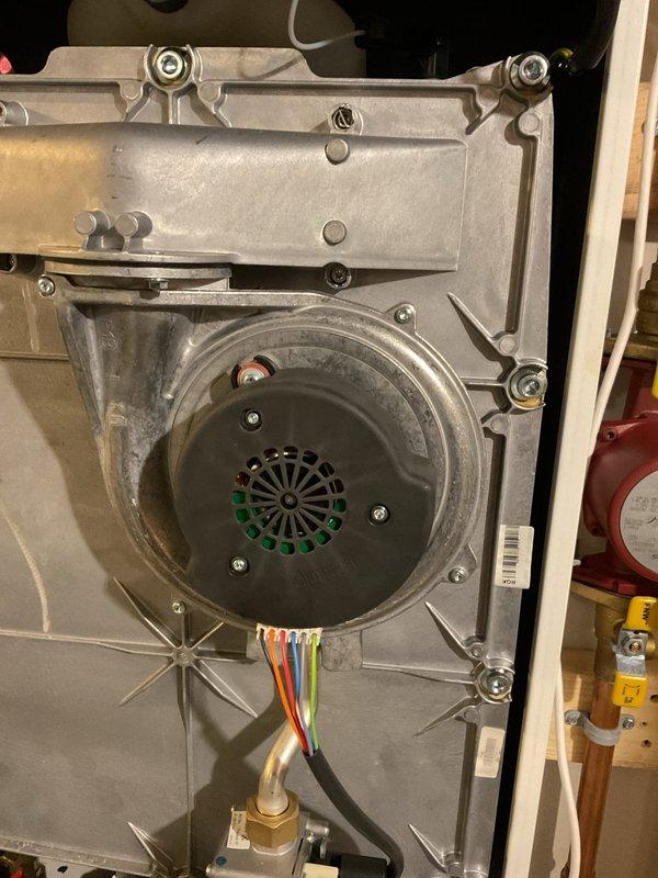 Responded to service call for tankless water heater throwing F008 error code (indicating incorrect fan speed). After consultation with IBC technical support, identified faulty fan assembly requiring replacement. Removed and inspected existing fan unit, noting wear on the aluminum housing and electrical connections. Fan replacement part has been ordered through parts department to resolve the ongoing system issues that have persisted since installation 9 months ago.