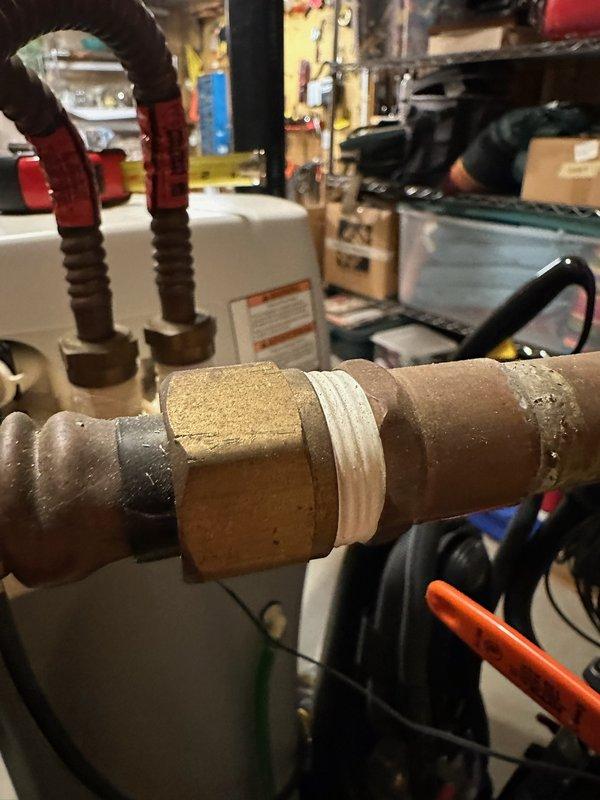 Diagnosed and repaired a pinhole leak on the water softener supply connector at the water heater. Replaced deteriorated copper supply lines with new braided flexible connectors, ensuring proper sealing with thread tape at connection points to prevent future leaks.