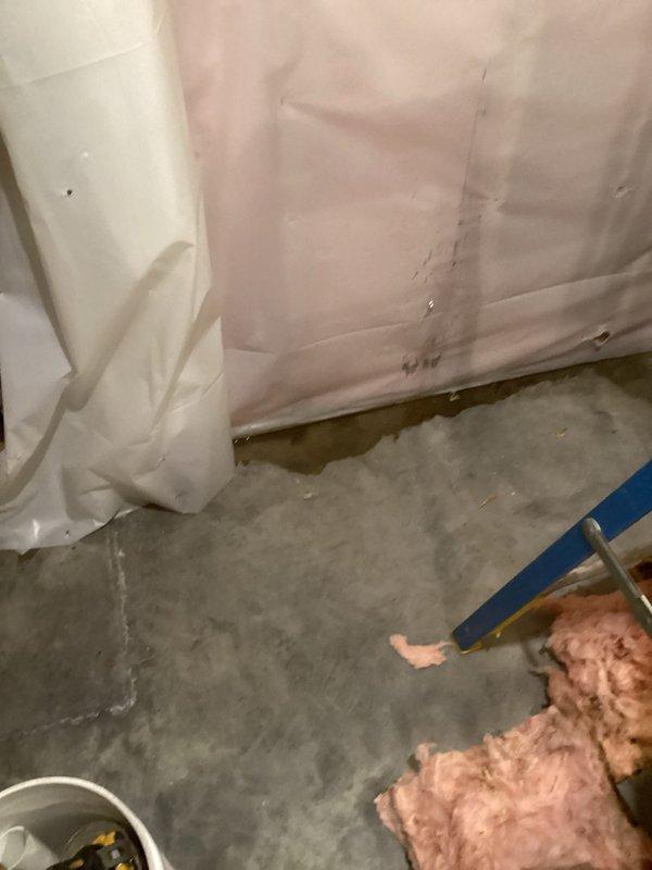 Diagnosed and repaired kitchen drain leak caused by cracked ABS pipe fittings. Accessed damaged section by removing dishwasher and cutting access through wall, then replaced approximately 2 feet of drain piping with new PVC components, securing with appropriate clamps and connectors to prevent future leakage.