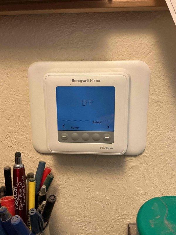 Responded to warranty service call for 1-year-old Lennox system where thermostat was displaying "temp hold" and reverting to 62°F despite adjustment attempts. Disabled programming function on the Honeywell ProSeries thermostat to provide customer with full manual temperature control and reset the Aprilaire humidifier maintenance indicator following recent pad replacement. System now functioning properly with all issues resolved.