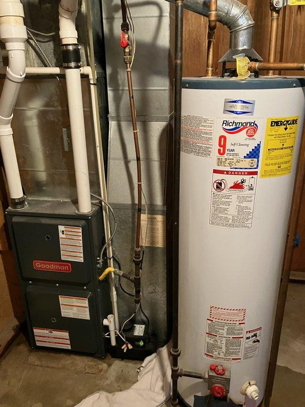 Successfully replaced leaking 40-gallon natural gas water heater in basement with new Richmond 9-year warranty model. Installed standard vent system with proper gas line connections and verified all plumbing connections were secure and operational.