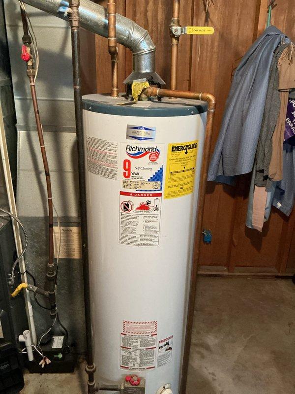 Successfully replaced leaking 40-gallon natural gas water heater in basement with new Richmond 9-year warranty model. Installed standard vent system with proper gas line connections and verified all plumbing connections were secure and operational.