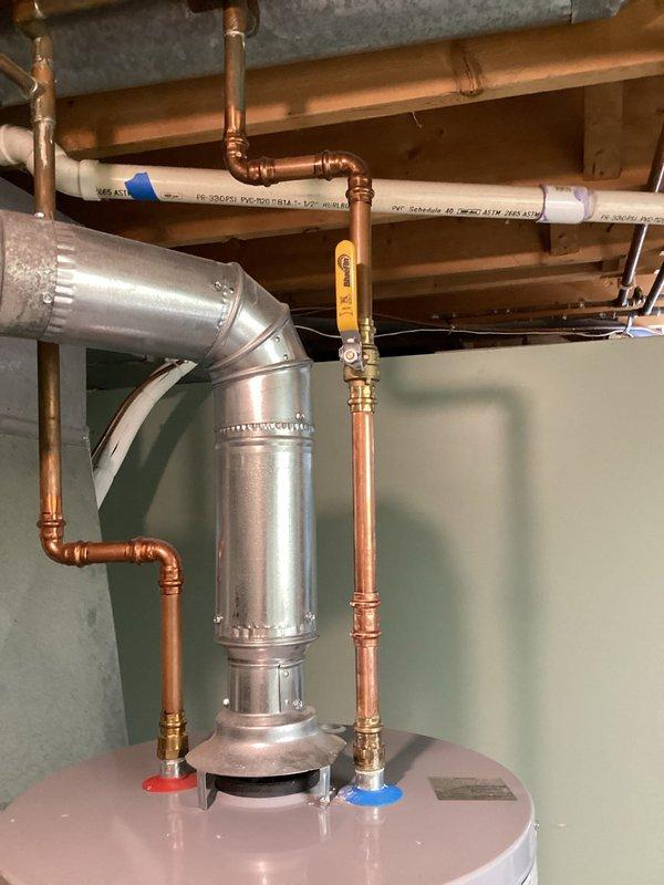 Responded to service call for water heater leaking at the top connection. Diagnosed a pinhole leak in the BluFin ball valve which had caused significant mineral buildup and corrosion on the copper pipe. Replaced the defective ball valve to resolve the leak.