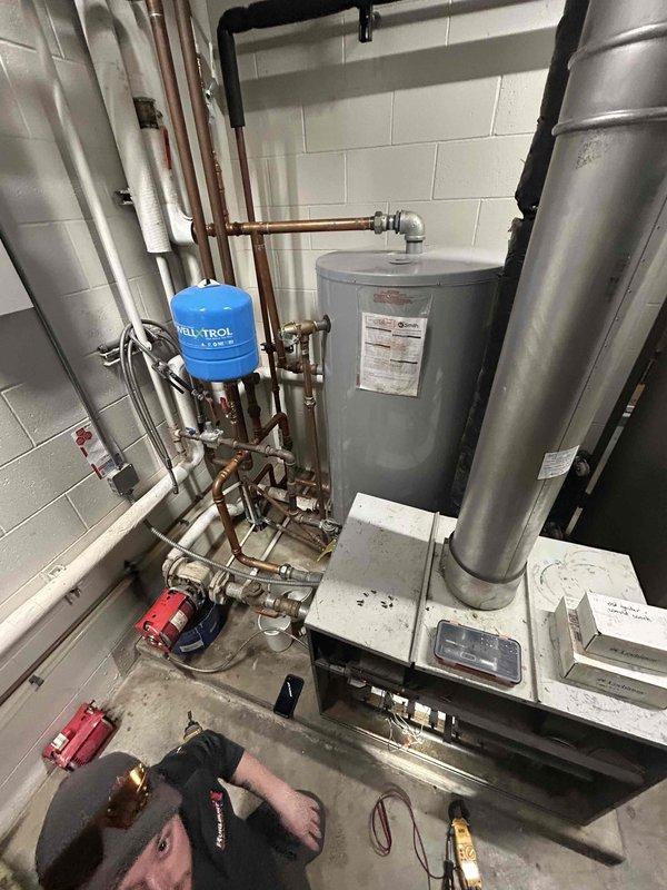 Responded to service call for Lochinvar boiler that was not producing hot water. Diagnosed issue as flame sense failure causing boiler to light and drop out; additionally discovered cracked pressure switch hose. Replaced pressure switch hose to restore temporary operation and recommended replacement ignitor, which has been ordered.