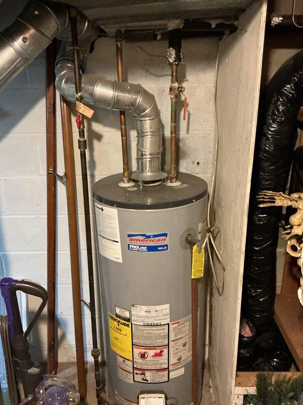 Conducted on-site assessment for laundry room relocation from main level to basement in split-level home. Evaluated existing water heater installation and exterior drainage system to determine feasibility of converting current laundry space into full bathroom while establishing new utility connections in basement for washer/dryer placement.