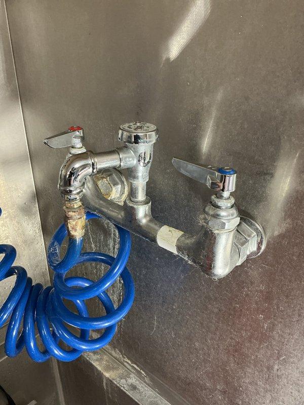 Inspected commercial dual-handle faucet assembly with broken spout and no existing shut-off valve. Measured 8" center-to-center spread and documented current installation with photographs. Determined existing valves were not sealing properly when closed; submitted parts order form for two replacement faucets and necessary shut-off valve components.