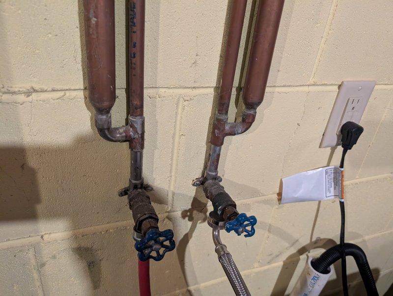 Responded to service call for plumbing issues. Discovered aging plumbing system with copper pipes showing oxidation and corrosion. Replaced leaking dishwasher valve and non-operable washing machine valves with new units including shock arrestors, resolving water supply issues and allowing for proper appliance function.