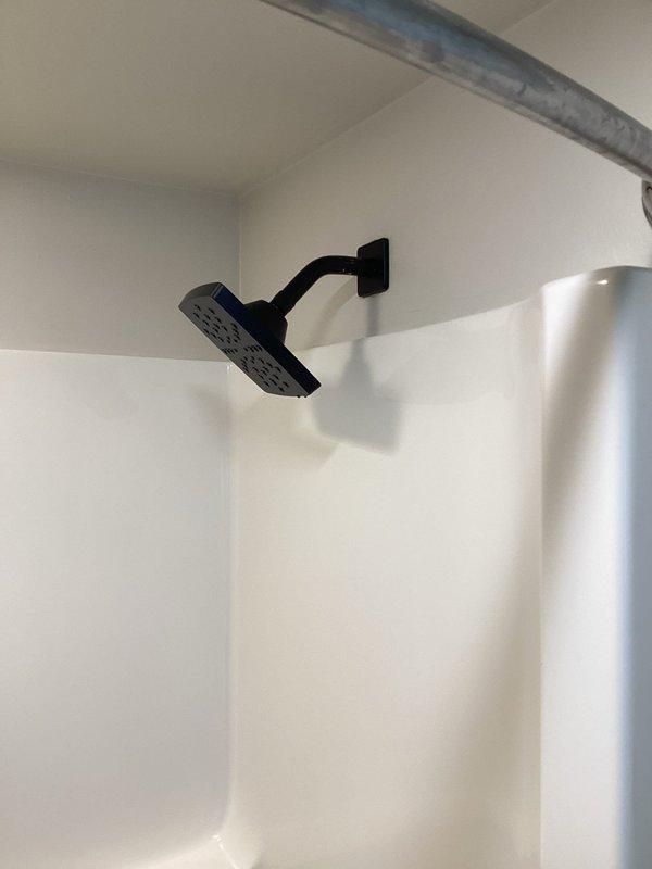 Responded to service call regarding whistling noise from recently replaced shower head. Identified incompatible tub trim brand provided by customer. Inspected black shower fixture and trim components. Submitted parts order form for replacement black tub trim, drains, and overflow to properly match existing components and eliminate noise issue.