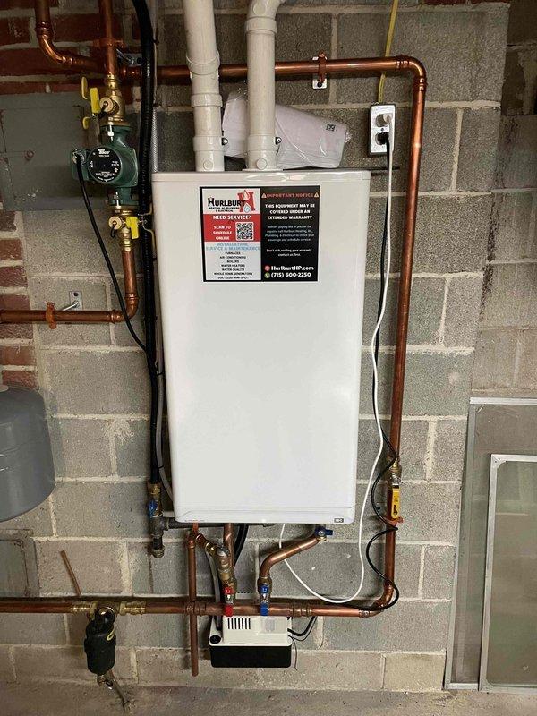 Responded to a no hot water call for a boiler system. Upon inspection, found the temperature setting on the gas valve was set to the lowest position. Adjusted the temperature dial to the appropriate hot setting, which successfully restored functionality and hot water service. Verified system operation with status indicator showing green.