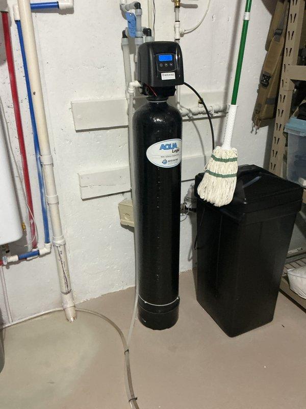 Installed air gap for water softener system as requested. System includes AQUAflow filtration unit with brine tank. Added funnel for floor drain to improve drainage performance.