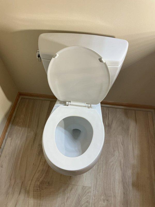 Installed two comfort height elongated toilets as requested by customer. Replaced angle stops and supply lines for both fixtures. Secured toilet flanges to concrete floor with anchors as they were previously unsecured, ensuring proper installation and preventing future movement.